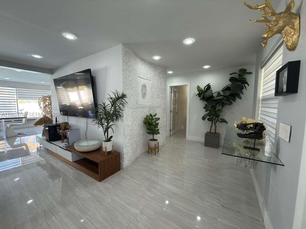 4801 West Park Road Hollywood, FL 33021 - Photo 9 of 30 a living room with furniture and a potted plant