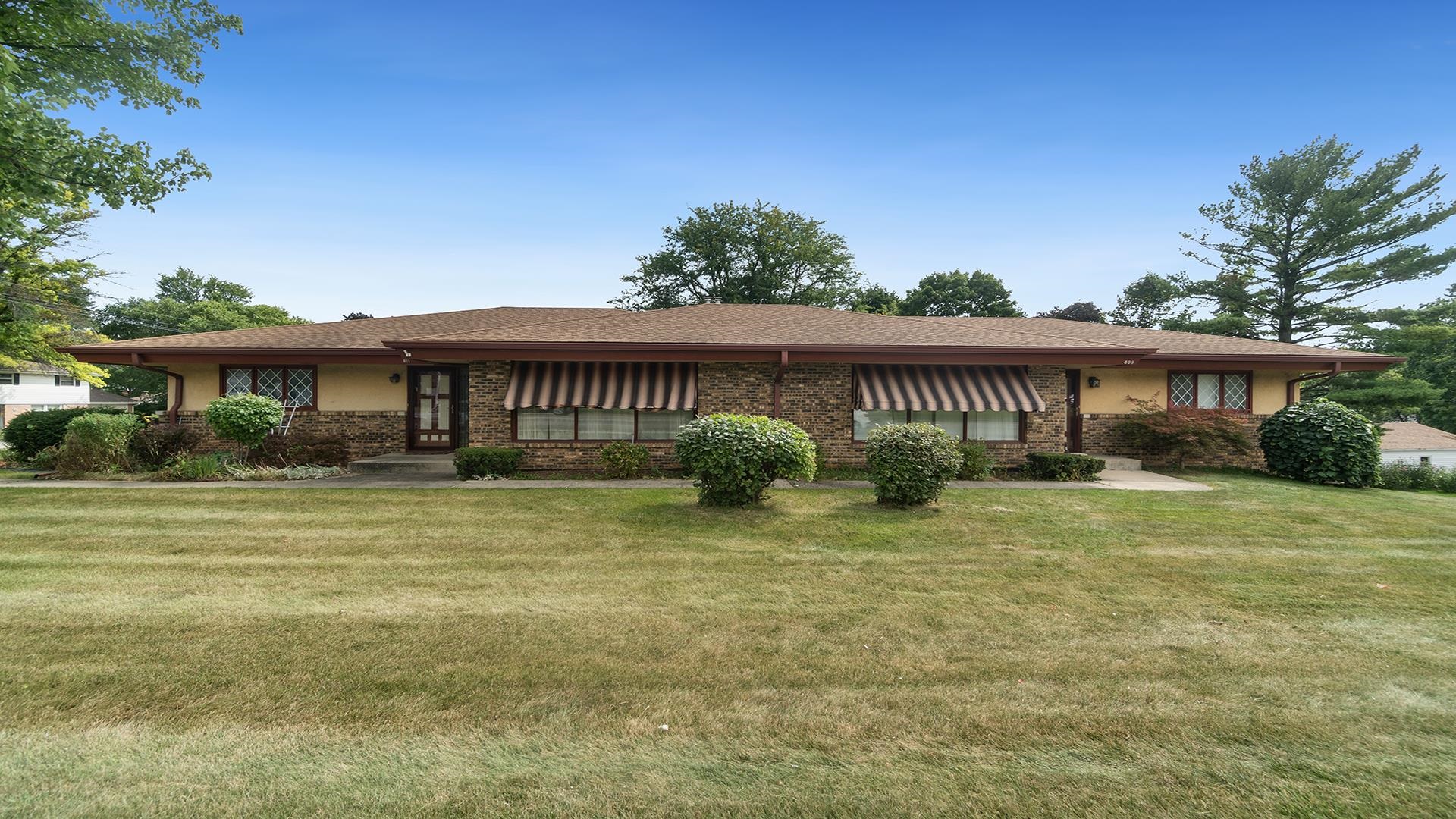 809 North Alpine Road Rockford, IL 61107 - Photo 1 of 48 a front view of a house with a garden