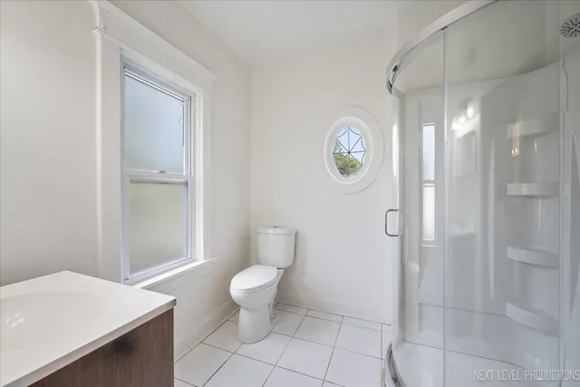 a bathroom with a toilet a sink and a shower