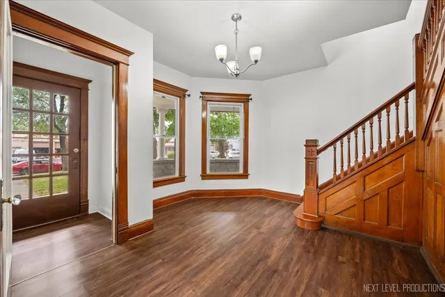 a view of an entryway with wooden floor and door