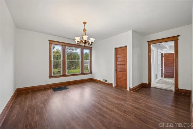 a view of a room with wooden floor gym equipment and windows