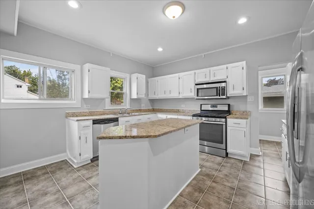 a kitchen with a refrigerator sink and stove