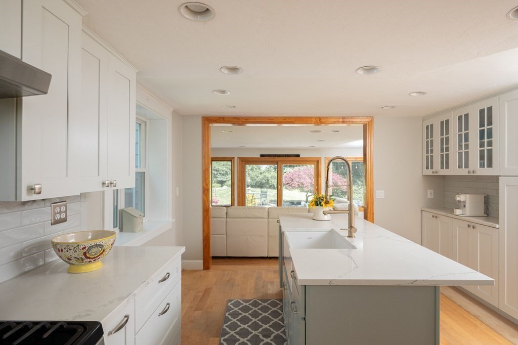 79 North Street Hanover, MA 02339 - Photo 12 of 42 a kitchen with a sink stove and cabinets