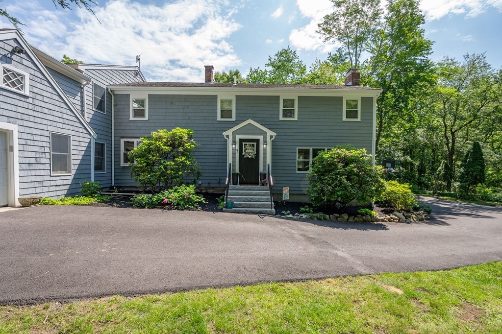 79 North Street Hanover, MA 02339 - Photo 2 of 42 a front view of a house with a garden and trees