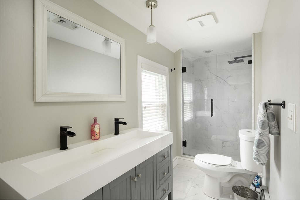 79 North Street Hanover, MA 02339 - Photo 22 of 42 a bathroom with a sink toilet vanity and shower