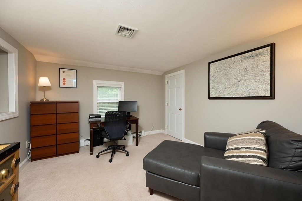 79 North Street Hanover, MA 02339 - Photo 23 of 42 a livingroom with workspace and a couch