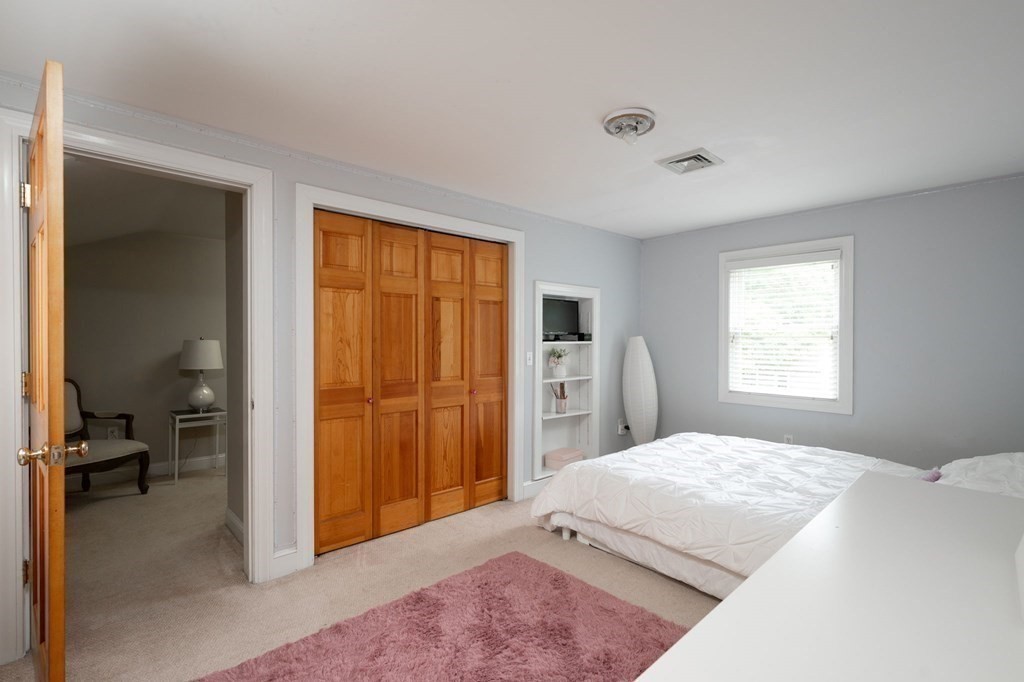 79 North Street Hanover, MA 02339 - Photo 24 of 42 a bedroom with a bed and a table in it