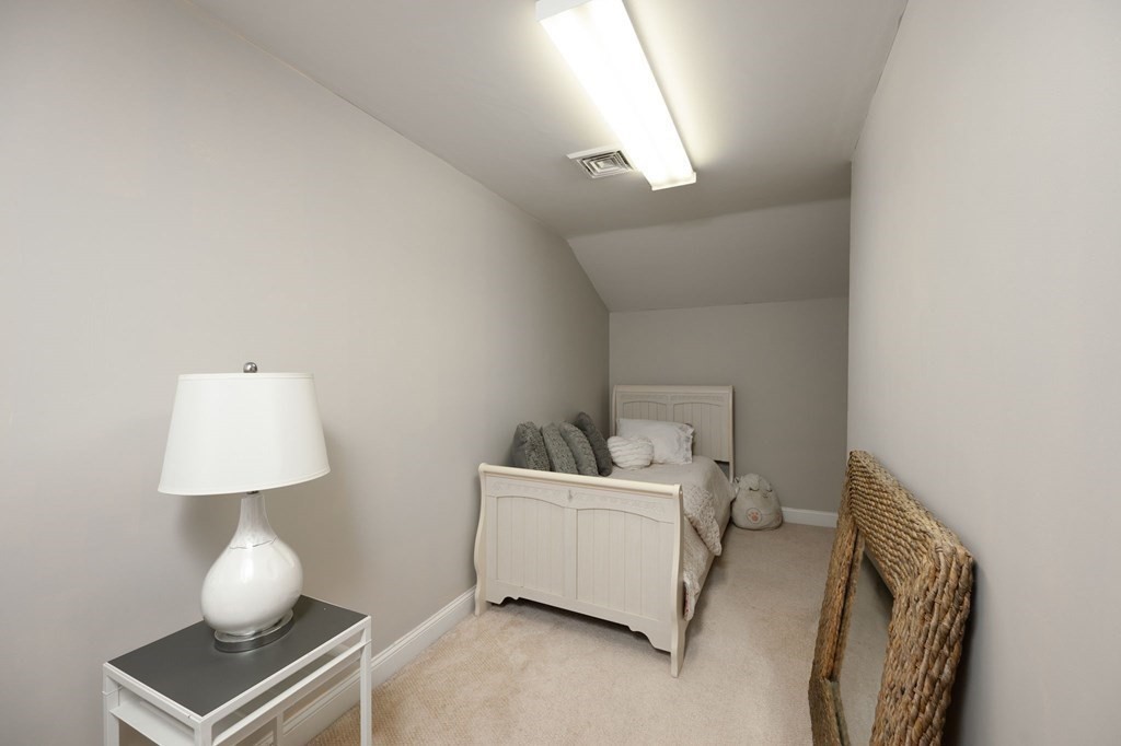 79 North Street Hanover, MA 02339 - Photo 25 of 42 a bedroom with a bed and a lamp