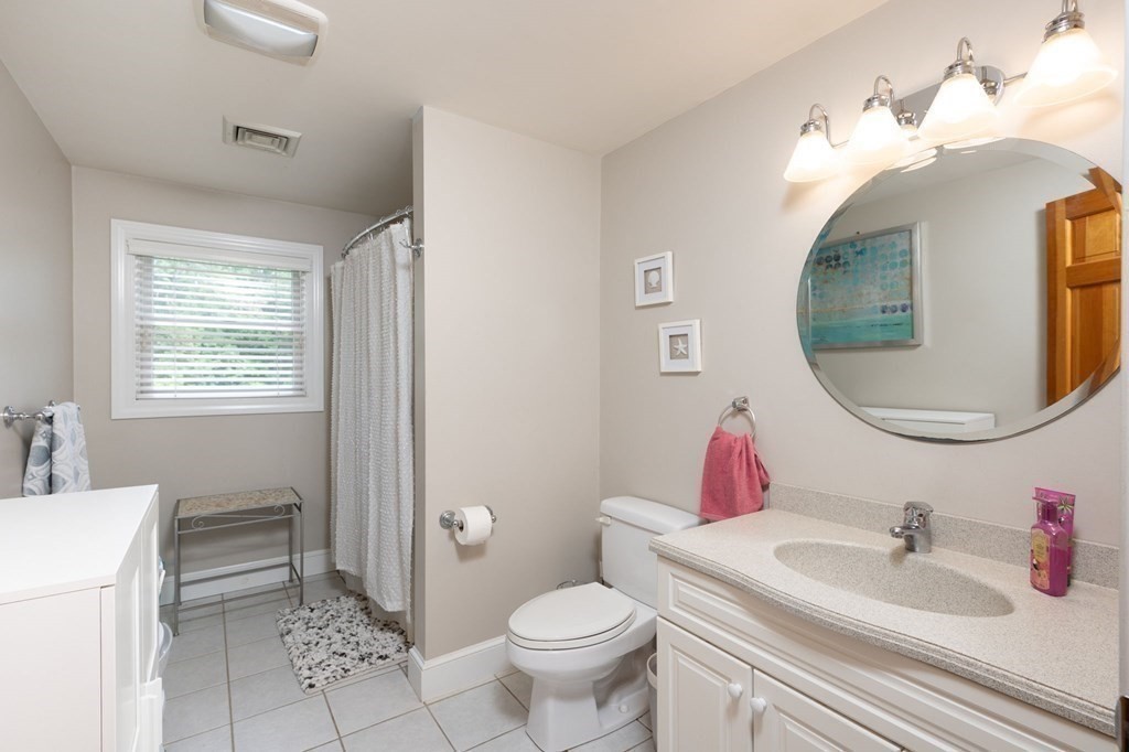 79 North Street Hanover, MA 02339 - Photo 26 of 42 a bathroom with a toilet sink vanity and mirror