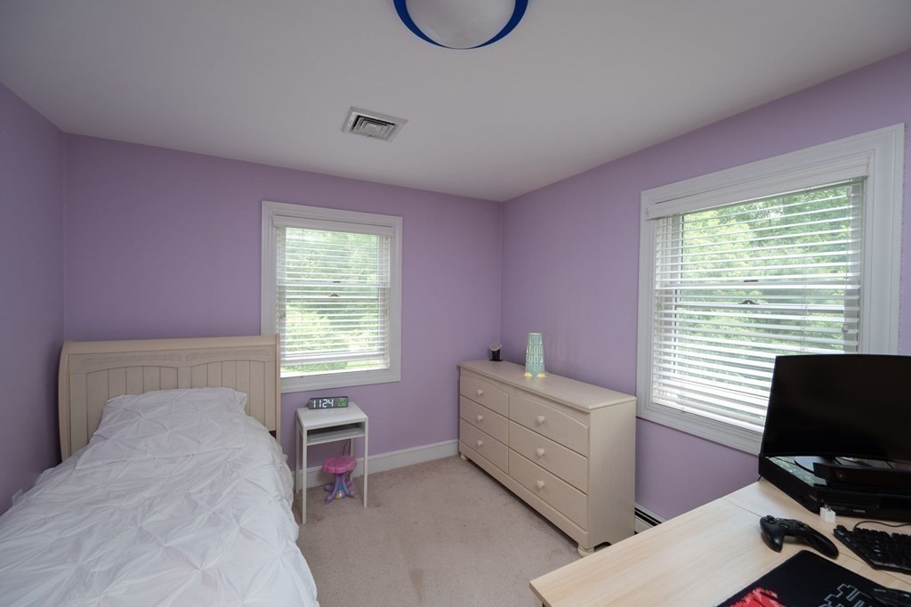 79 North Street Hanover, MA 02339 - Photo 27 of 42 a bedroom with a bed and a window