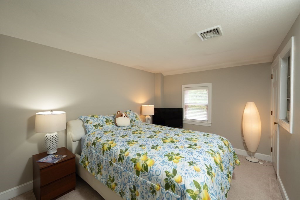 79 North Street Hanover, MA 02339 - Photo 28 of 42 a bedroom with a bed and wooden floor