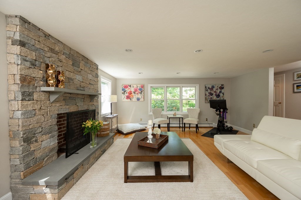 79 North Street Hanover, MA 02339 - Photo 5 of 42 a living room with furniture large window and a fireplace