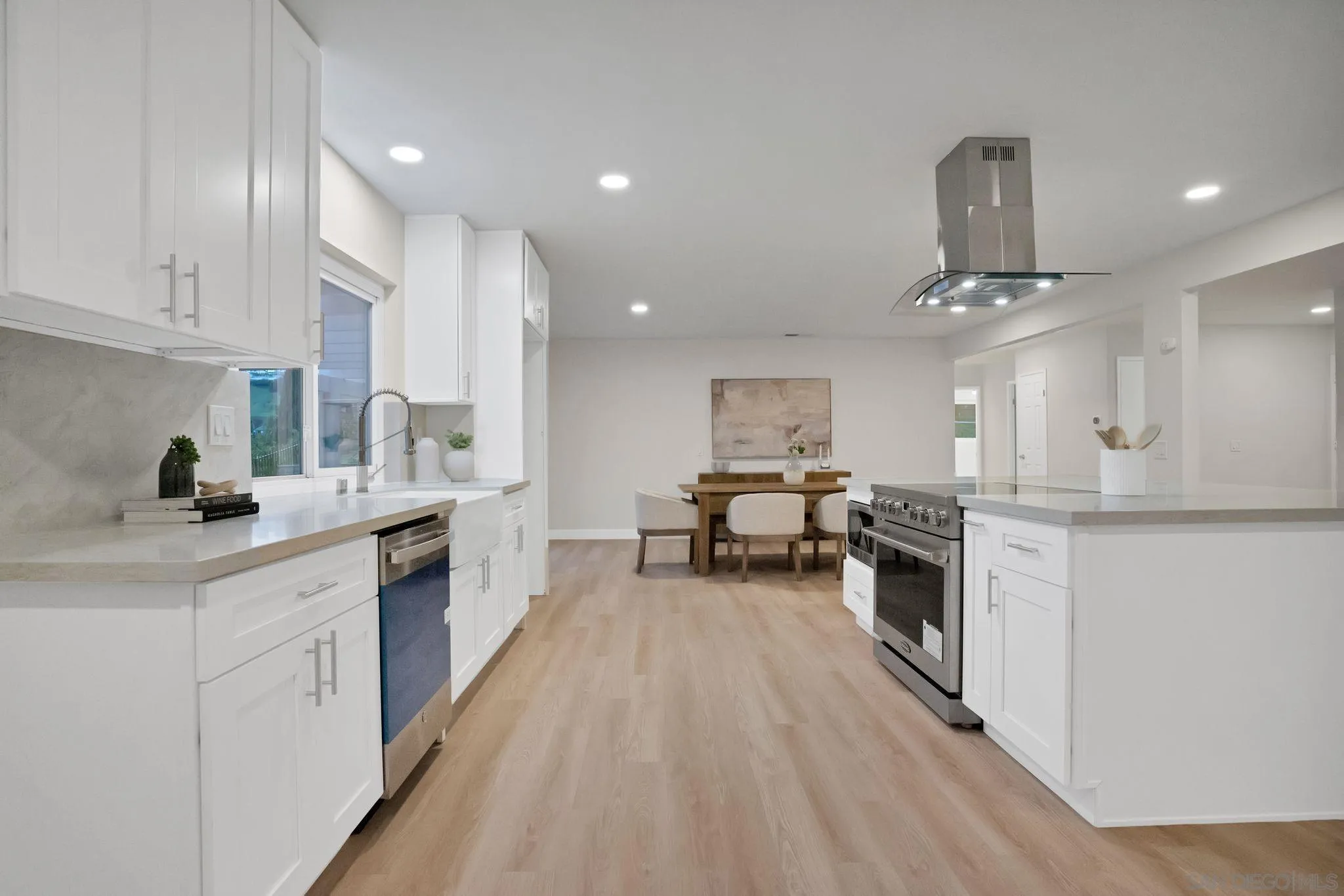 2796 Windmill View Road El Cajon, CA 92020 - Photo 4 of 14 a kitchen with stainless steel appliances a sink a stove a refrigerator cabinets and living room view
