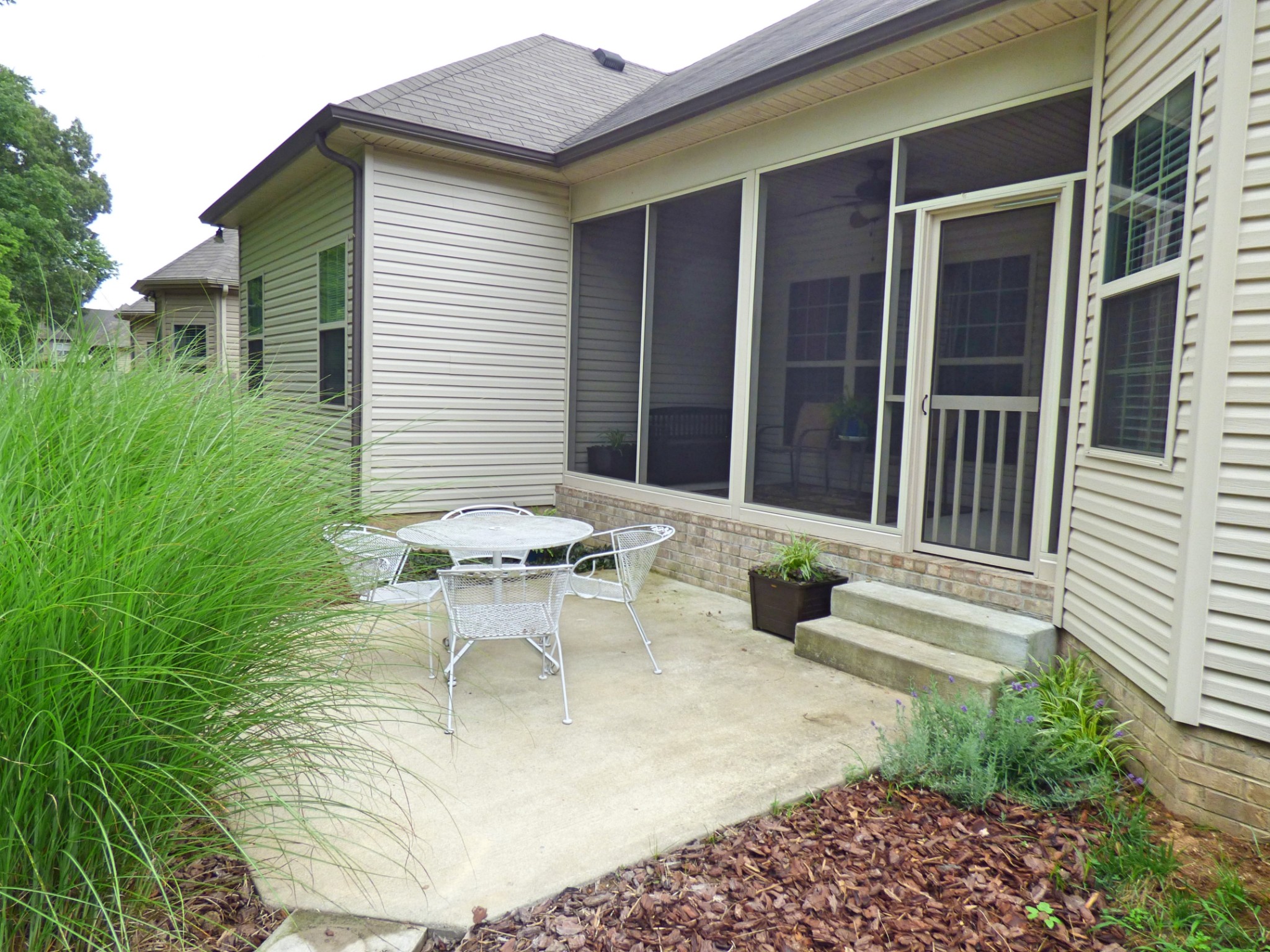 1076 Golf View Way Spring Hill, TN 37174 - Photo 19 of 19 a view of a patio with table and chairs and potted plants