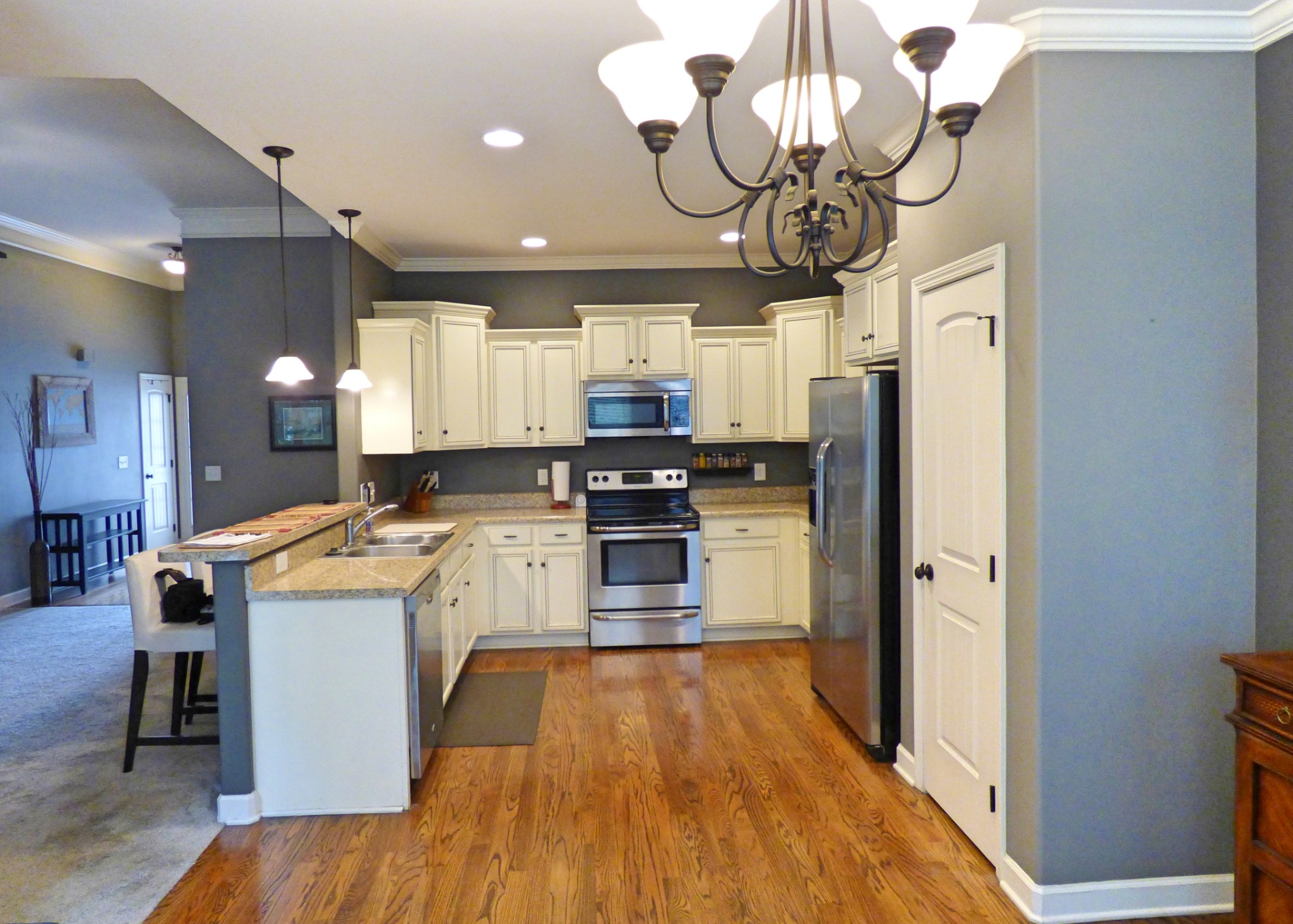 1076 Golf View Way Spring Hill, TN 37174 - Photo 5 of 19 a kitchen that has a lot of white cabinets and stainless steel appliances