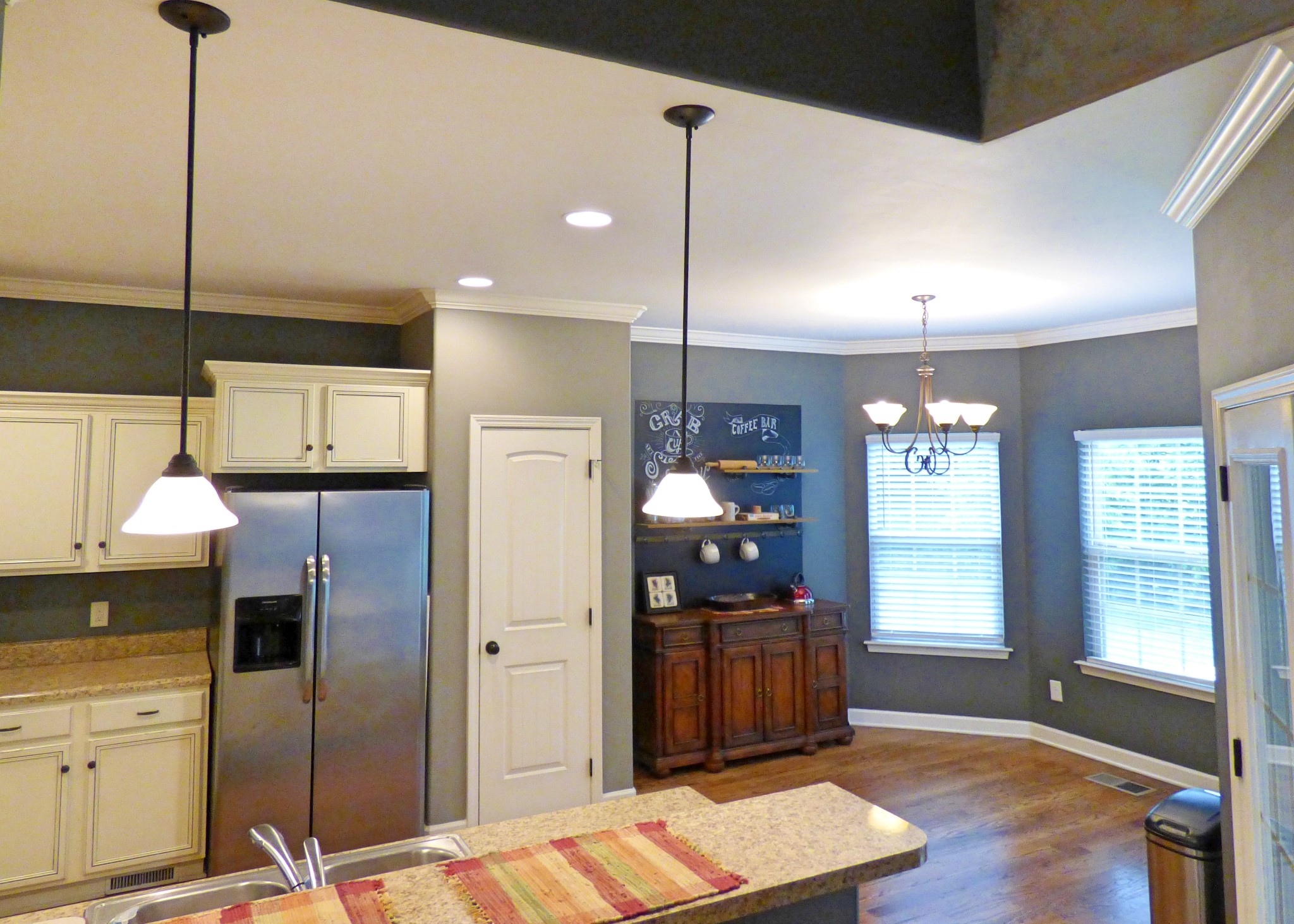 1076 Golf View Way Spring Hill, TN 37174 - Photo 7 of 19 a kitchen with stainless steel appliances kitchen island granite countertop a refrigerator a stove and a sink with wooden floor