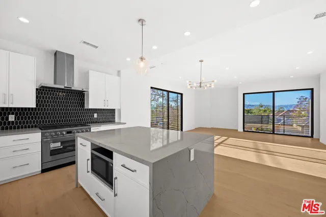 a kitchen with a stove a sink and a refrigerator