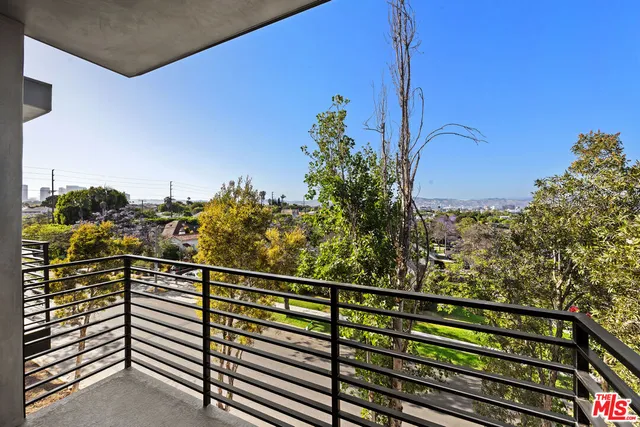 a view of a balcony with wooden floor and city view