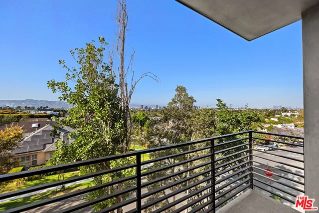 a view of a balcony with a floor to ceiling window next to a building