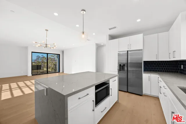a kitchen with a stove a refrigerator and a sink