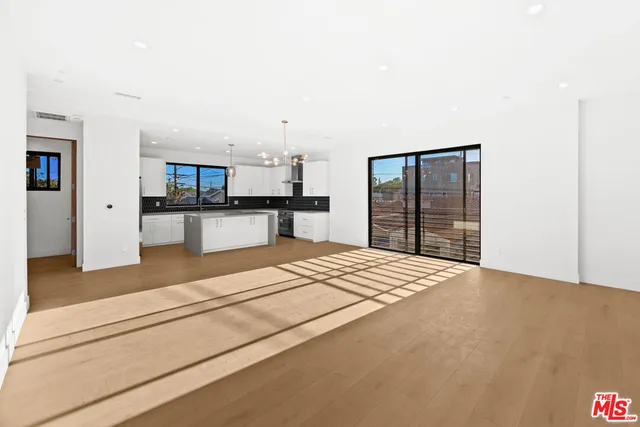 a large bedroom with a bed and a dresser