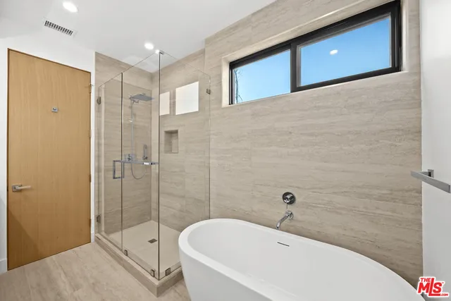a bathroom with a bathtub and shower