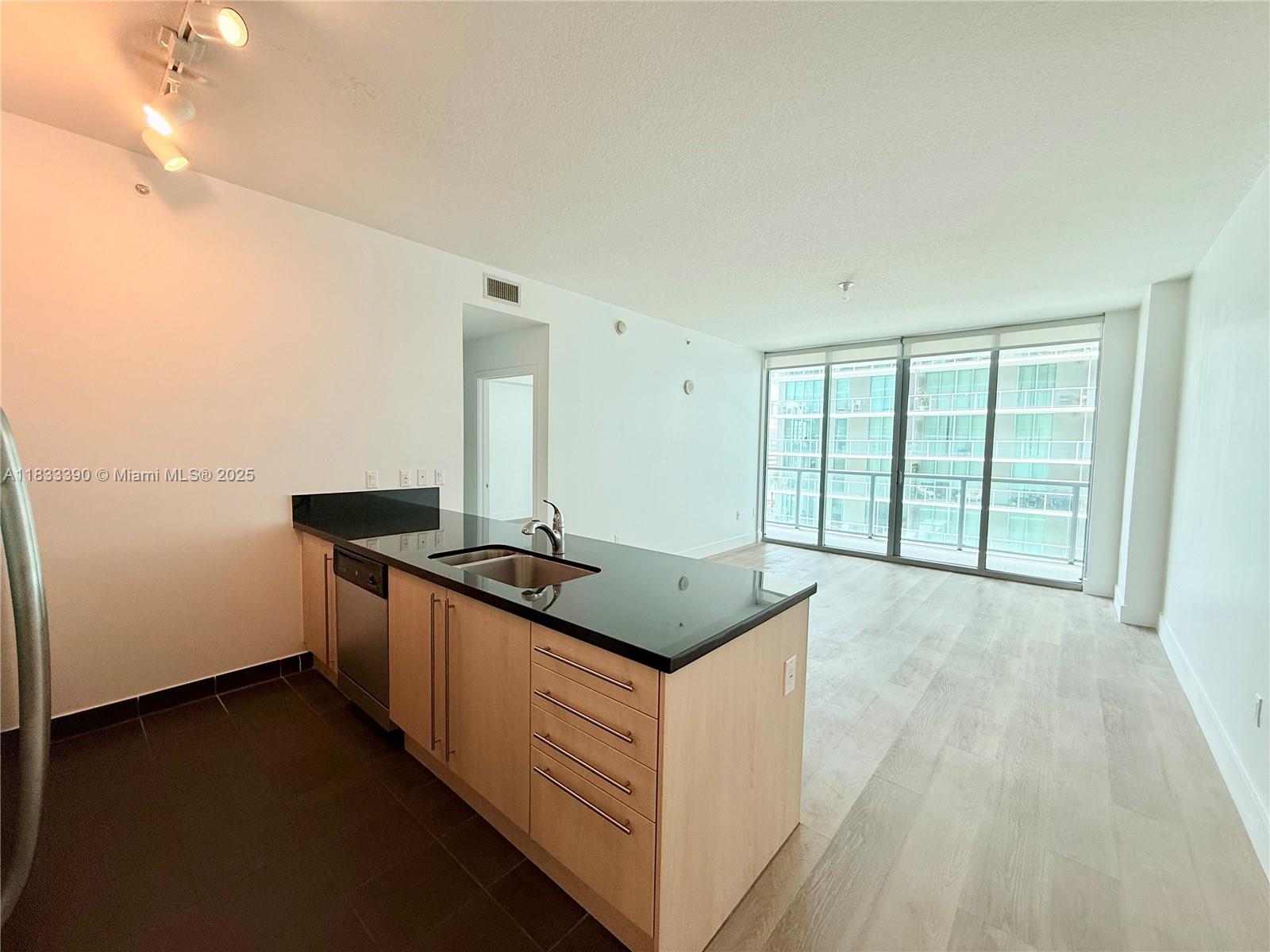 a kitchen with granite countertop a stove and a sink