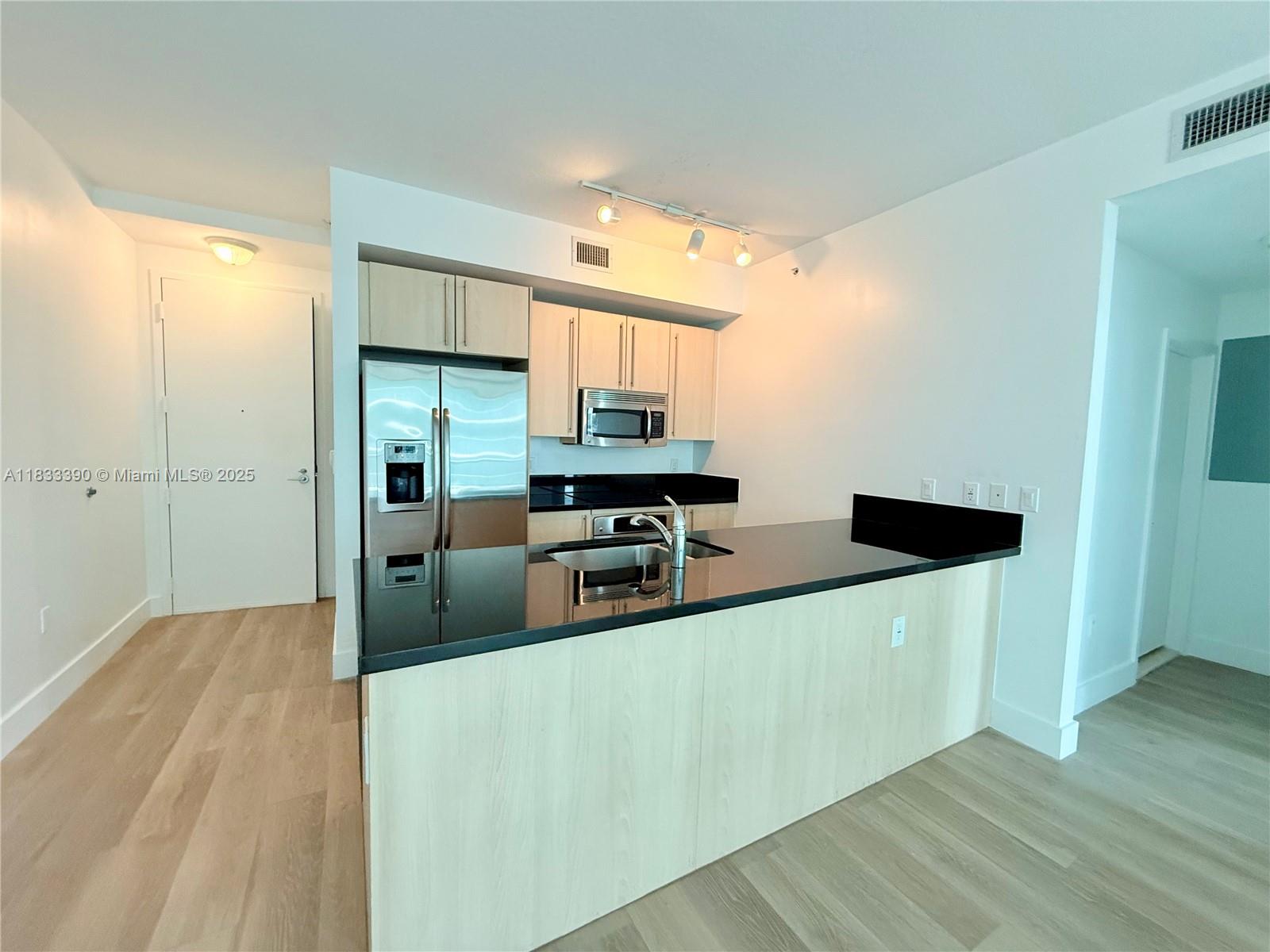 Brickell Miami, FL 33130 - Photo 2 of 15 a kitchen with stainless steel appliances a refrigerator and a stove