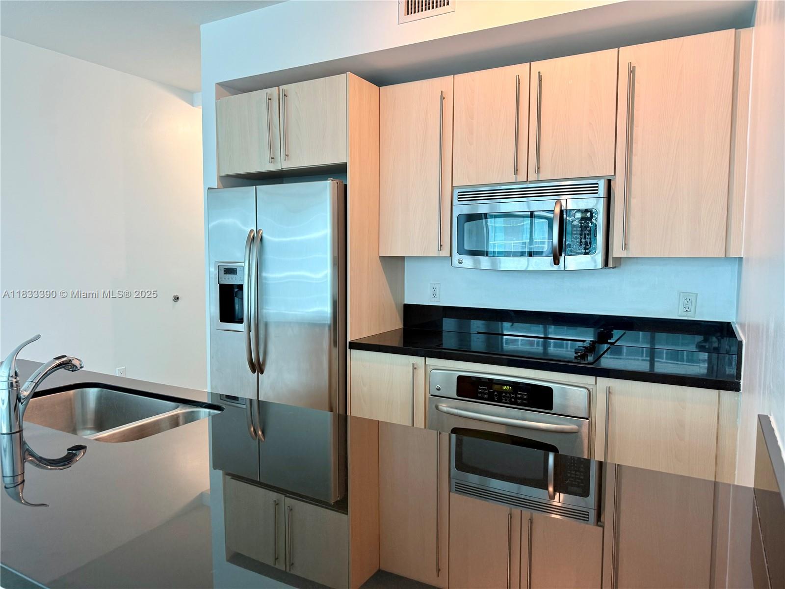 Brickell Miami, FL 33130 - Photo 3 of 15 a kitchen with a refrigerator and a sink