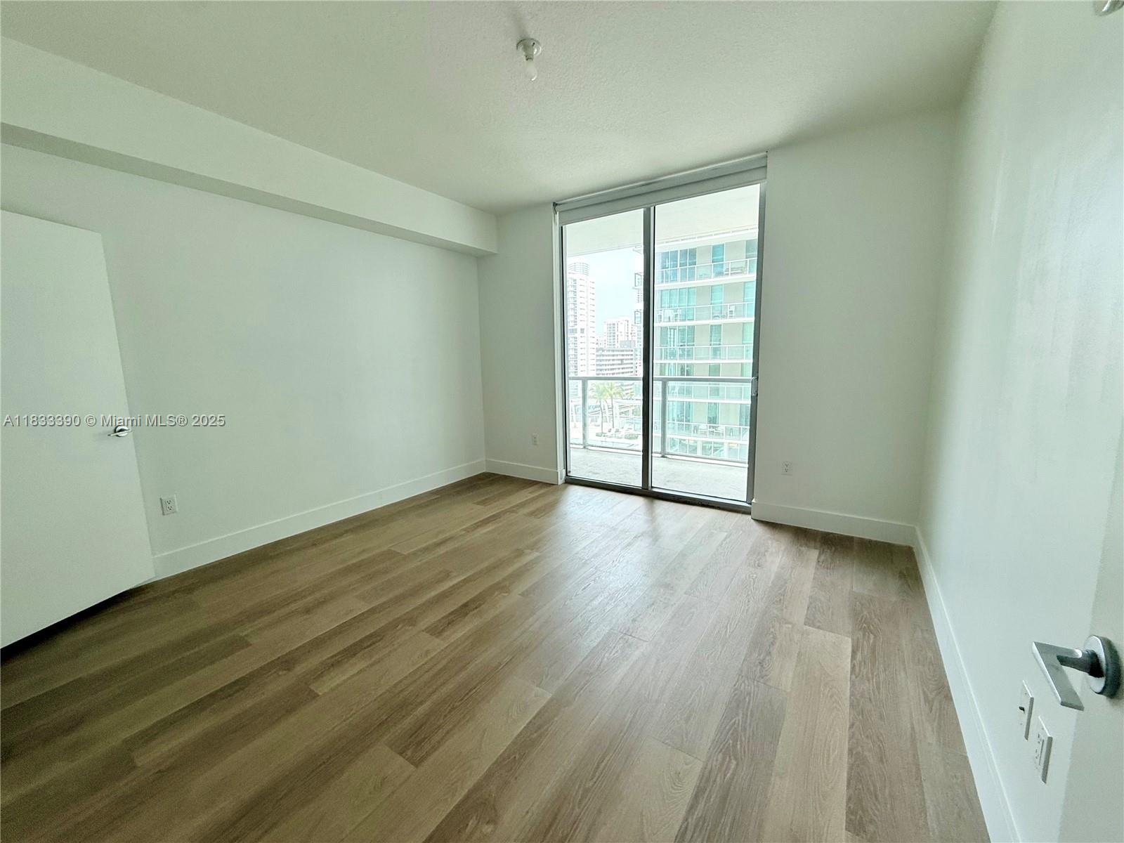 Brickell Miami, FL 33130 - Photo 8 of 15 a view of an empty room with wooden floor and a window