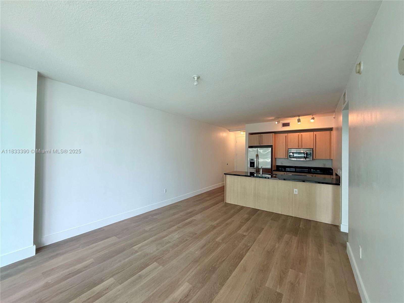 Brickell Miami, FL 33130 - Photo 9 of 15 a kitchen with a wooden floor and a stove