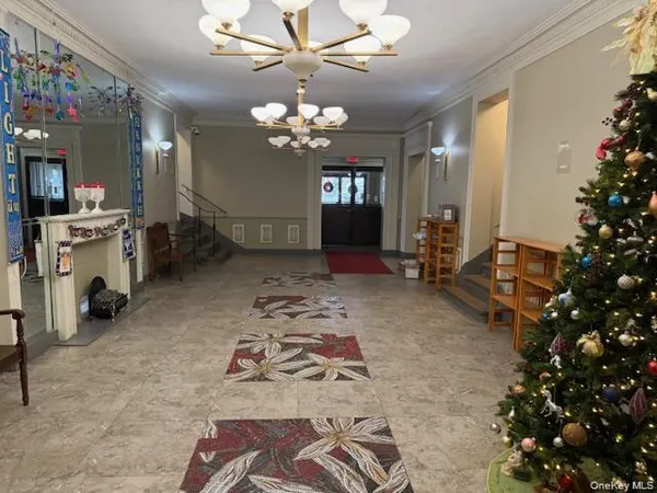 a living room with furniture and a chandelier