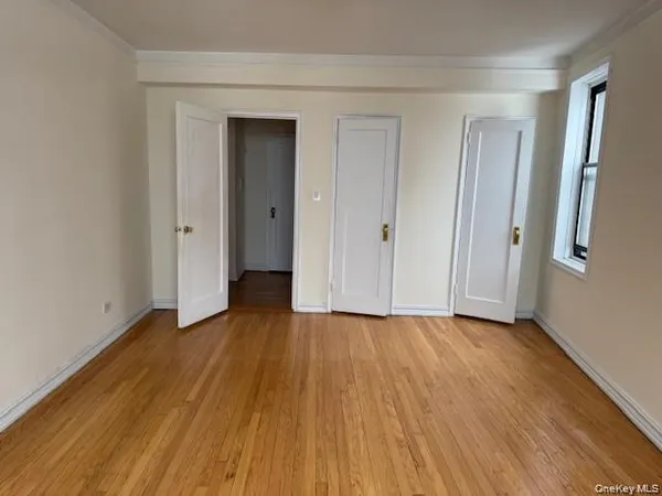 a view of an empty room and wooden floor