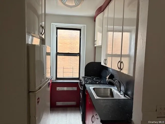 a kitchen with a sink a refrigerator and a window