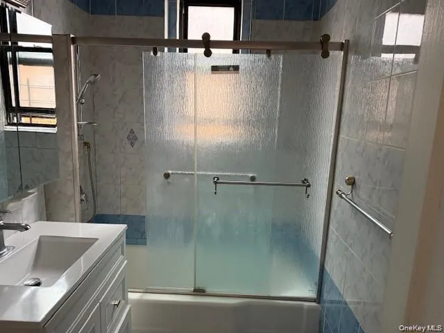 a bathroom with a tub a sink and shower
