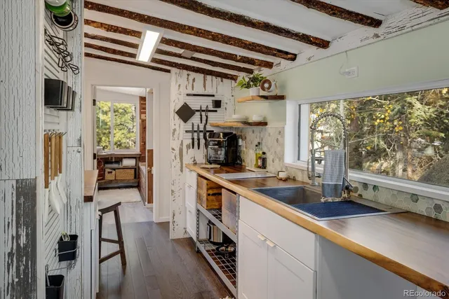 a kitchen with a sink stove and cabinets