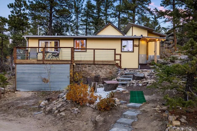a view of a house with a large tree and a yard