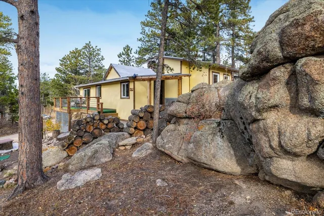 a view of deck with furniture and trees