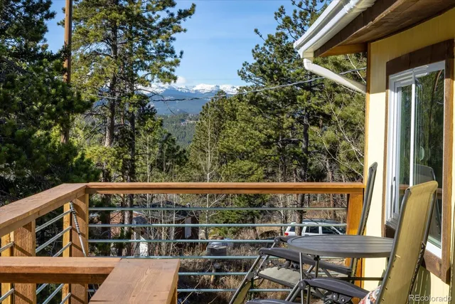 a view of a chair and table in the balcony