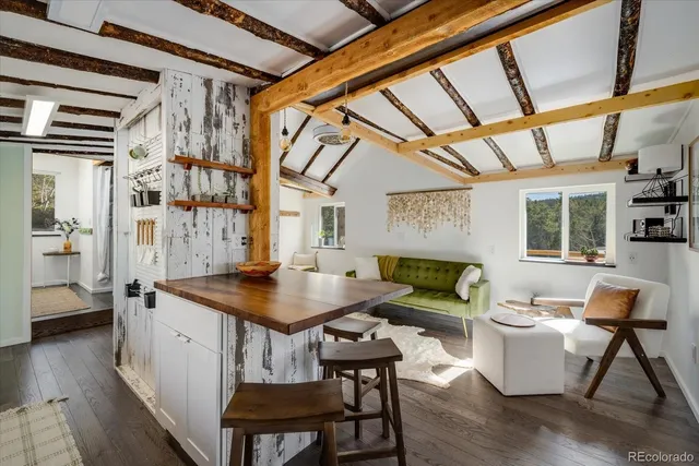 a kitchen with stainless steel appliances granite countertop a sink and a refrigerator