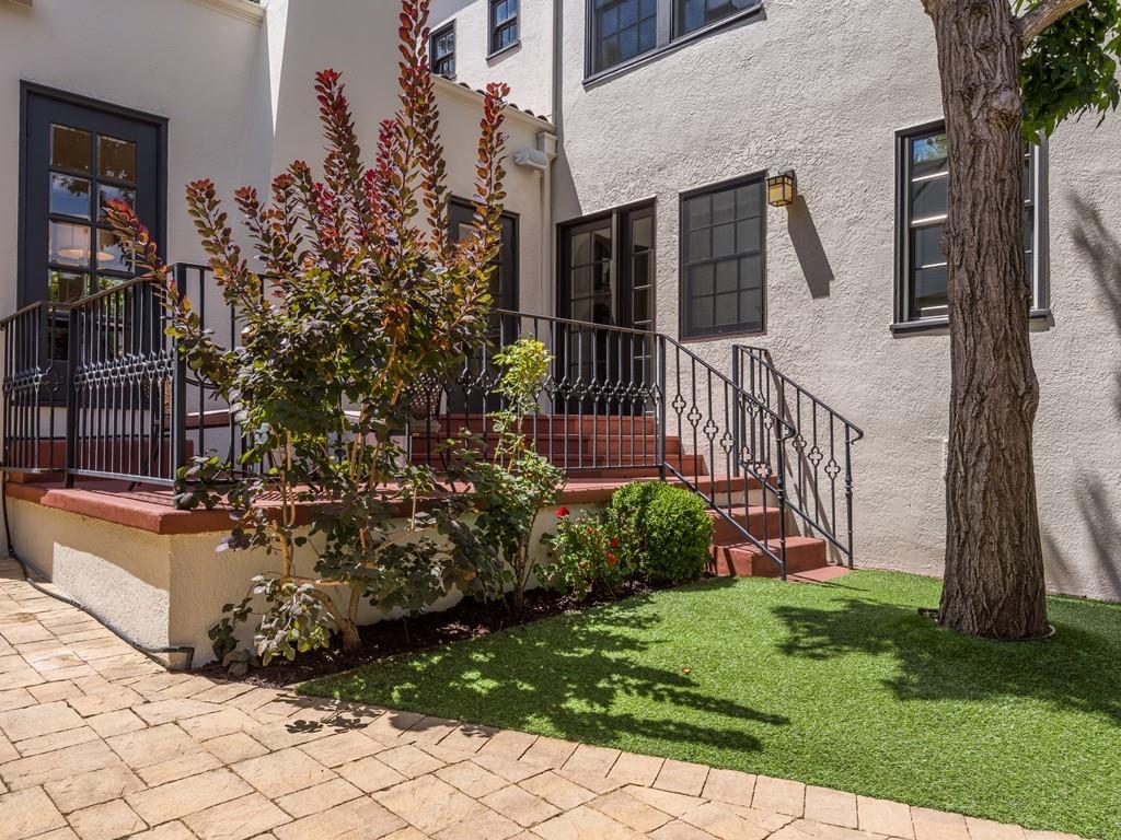 820 Crescent Avenue San Mateo, CA 94401 - Photo 23 of 27 a view of a house with brick walls and a yard with plants