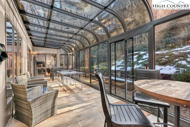 a building outdoor space with patio furniture and potted plants