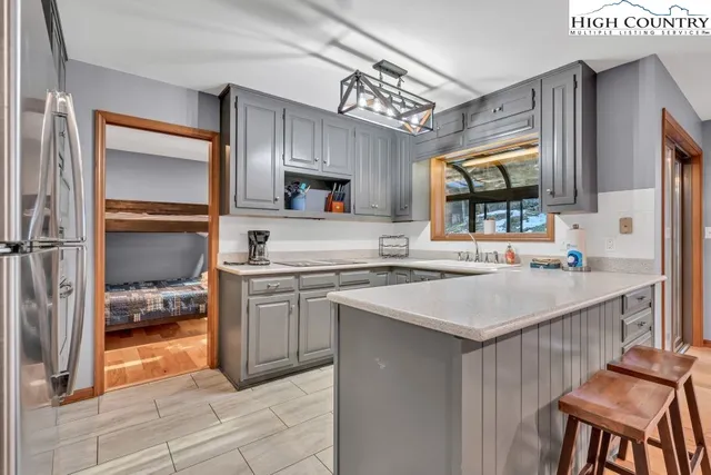 a kitchen with a sink appliances and cabinets