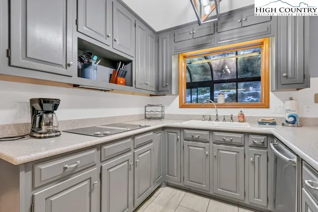 a kitchen with stainless steel appliances granite countertop a sink and a wooden cabinets