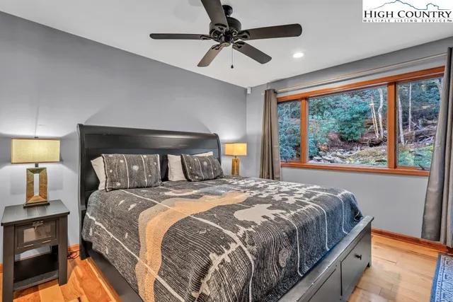 a bedroom with a large bed and a window