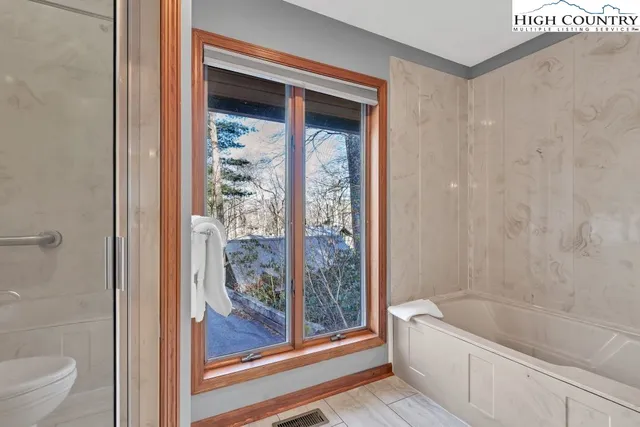 a bathroom with a bathtub a toilet and a shower