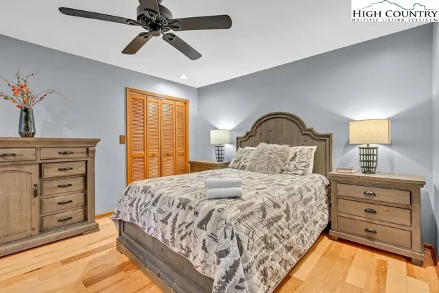 a bedroom with a large bed and a chandelier