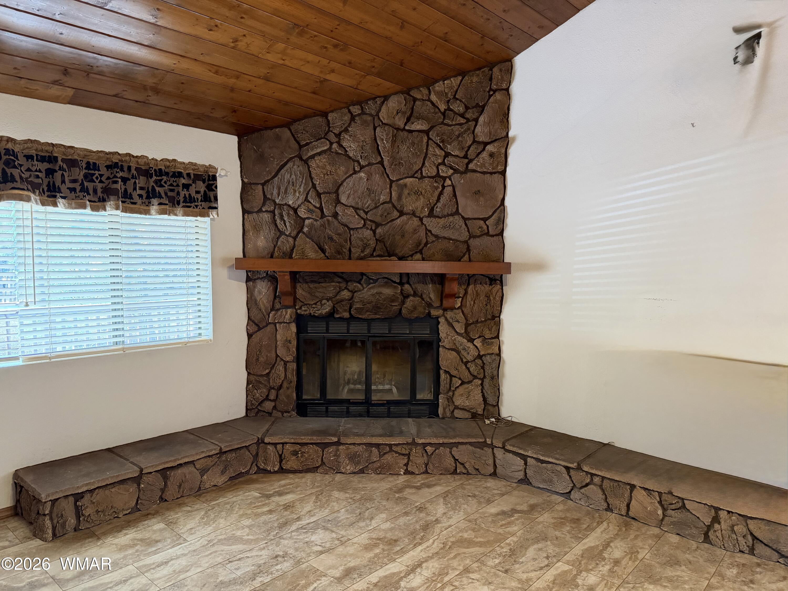 3225 Turkey Track Road Pinetop, AZ 85935 - Photo 8 of 25 stone wood burning fireplace in living room