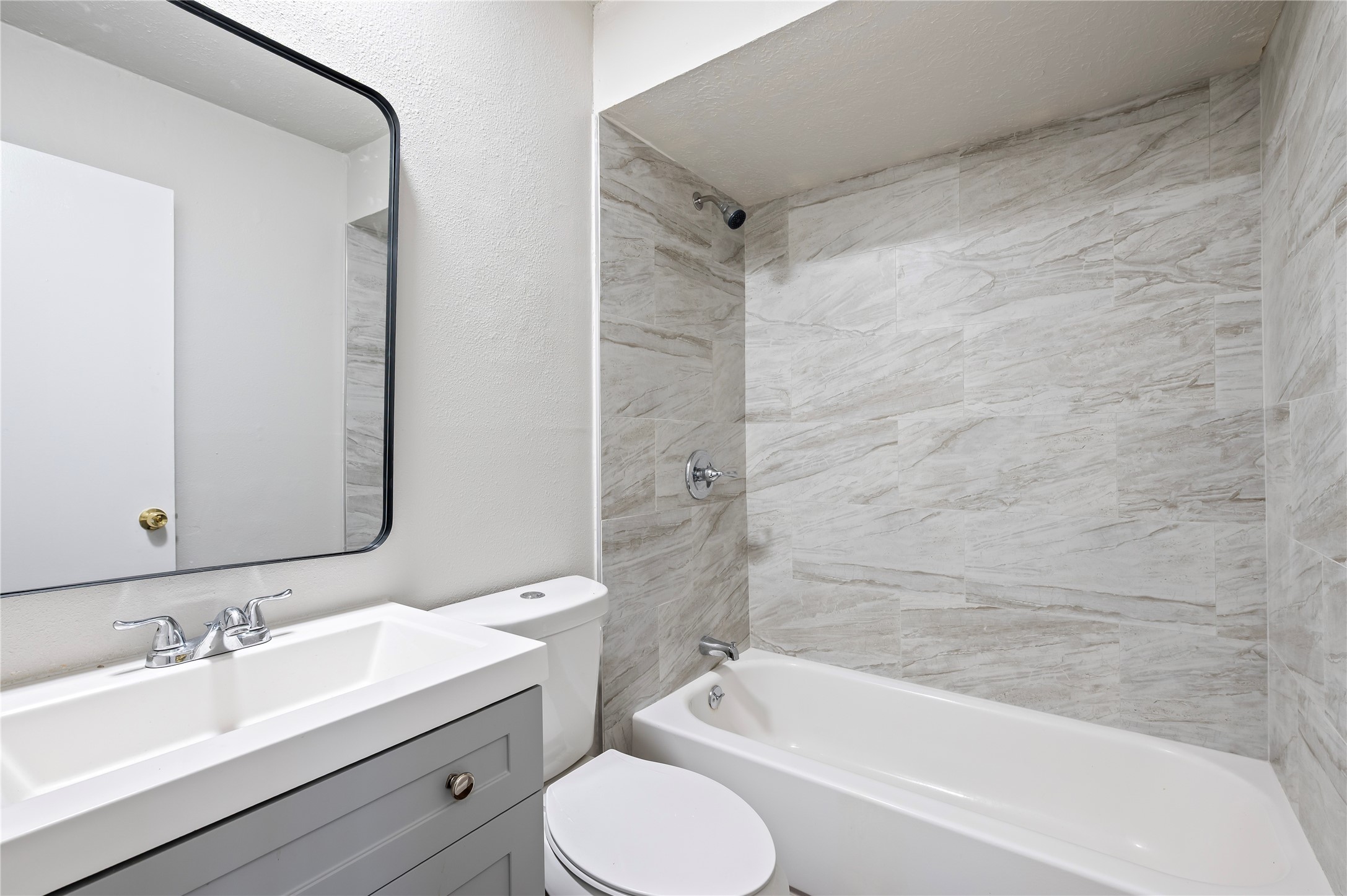 15050 Blueridge Road Missouri City, TX 77489 - Photo 14 of 30 a bathroom with a bathtub shower sink vanity mirror and toilet