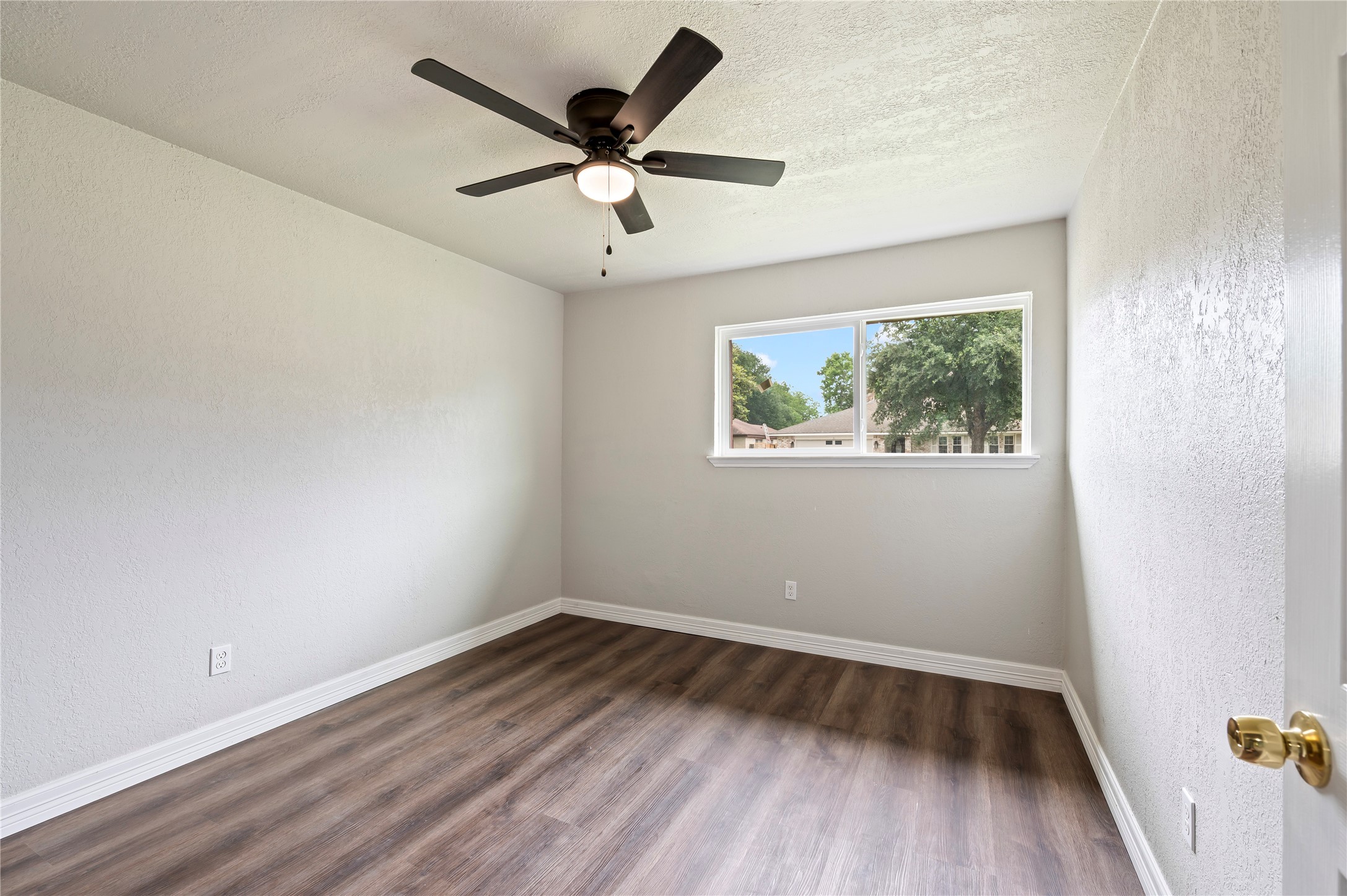 15050 Blueridge Road Missouri City, TX 77489 - Photo 16 of 30 an empty room with wooden floor and windows